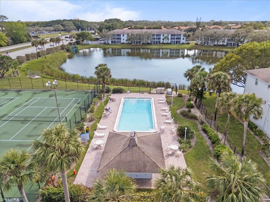 Outdoor swimming pool, paved pool deck, shaded gazebo, tennis court, and a pond