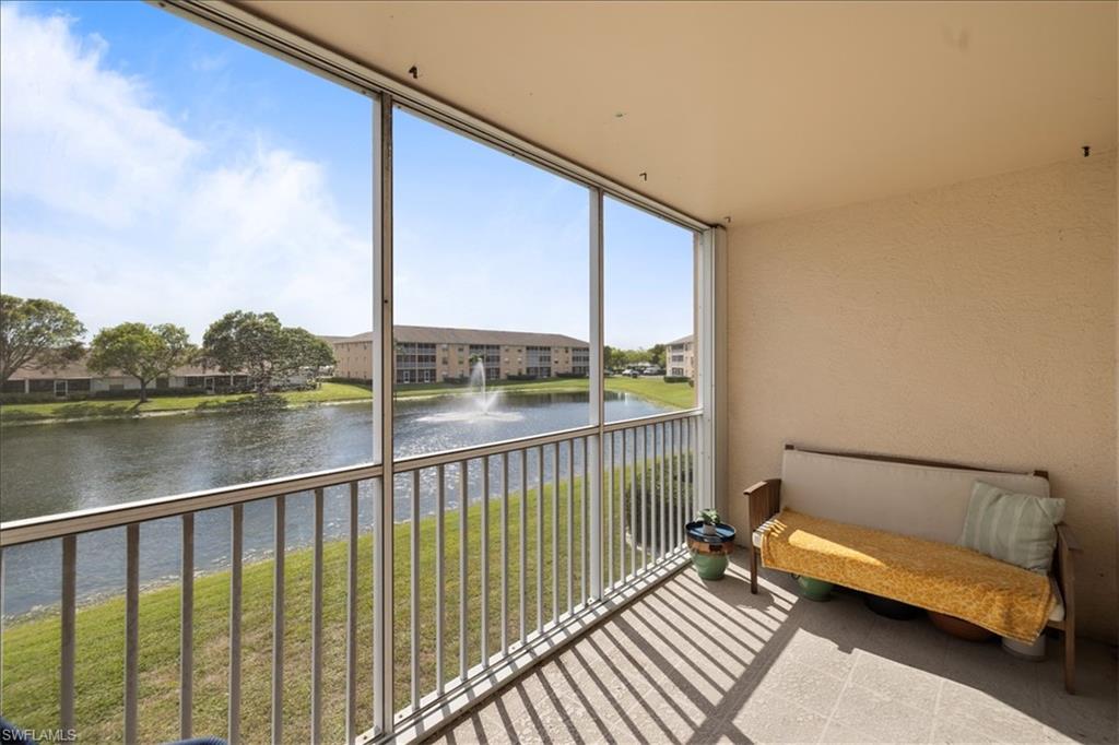 Screened balcony featuring tiled flooring and textured walls