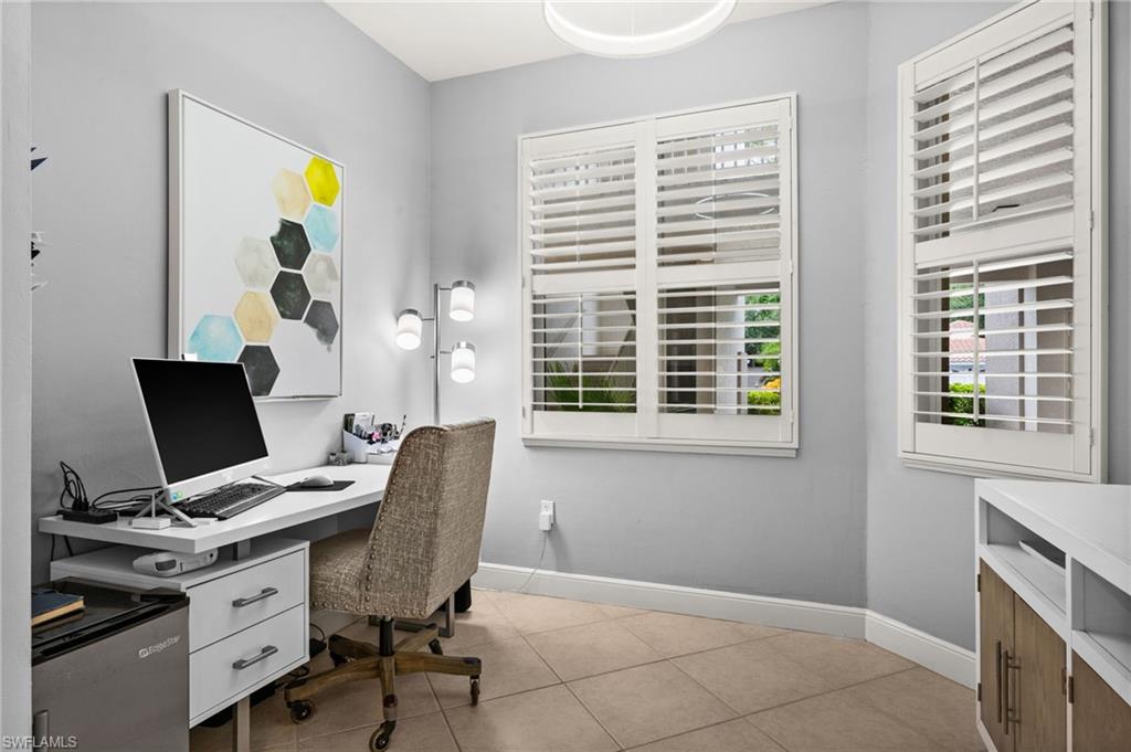 Floor-to-ceiling plantation shutters, neutral tile flooring, and a modern ceiling light fixture