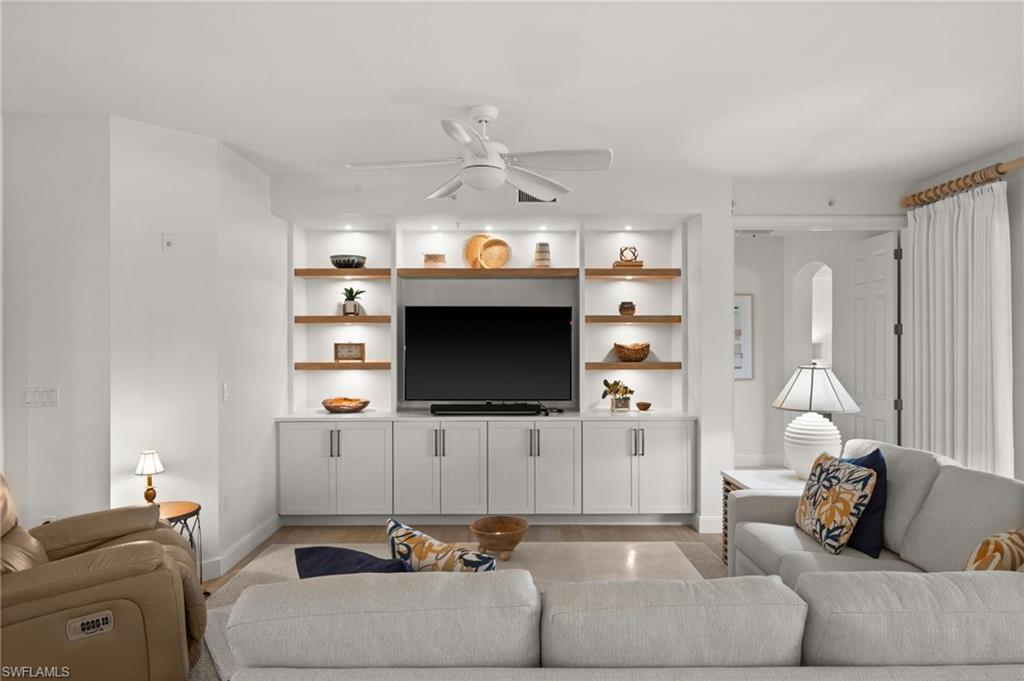 Built-in media center with integrated shelving and recessed lighting