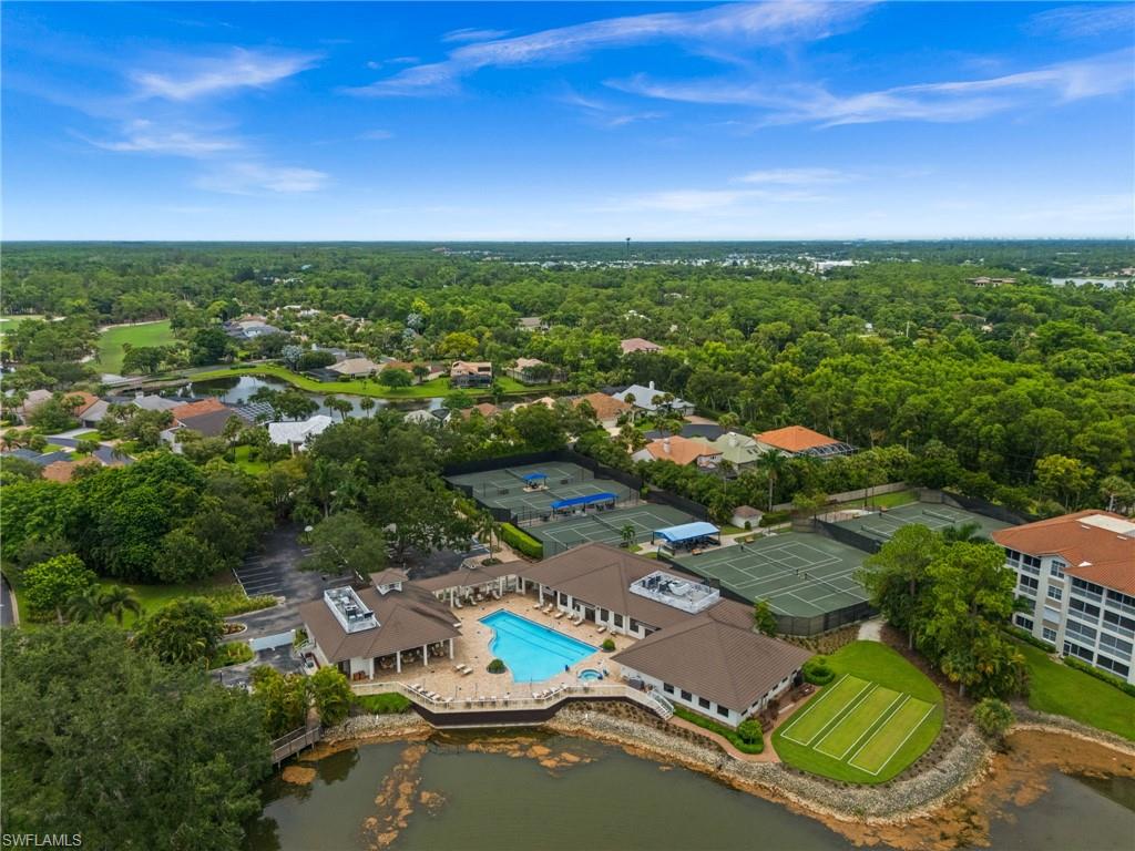 Aerial perspective showcasing a community pool, tennis courts, and bocce ball courts