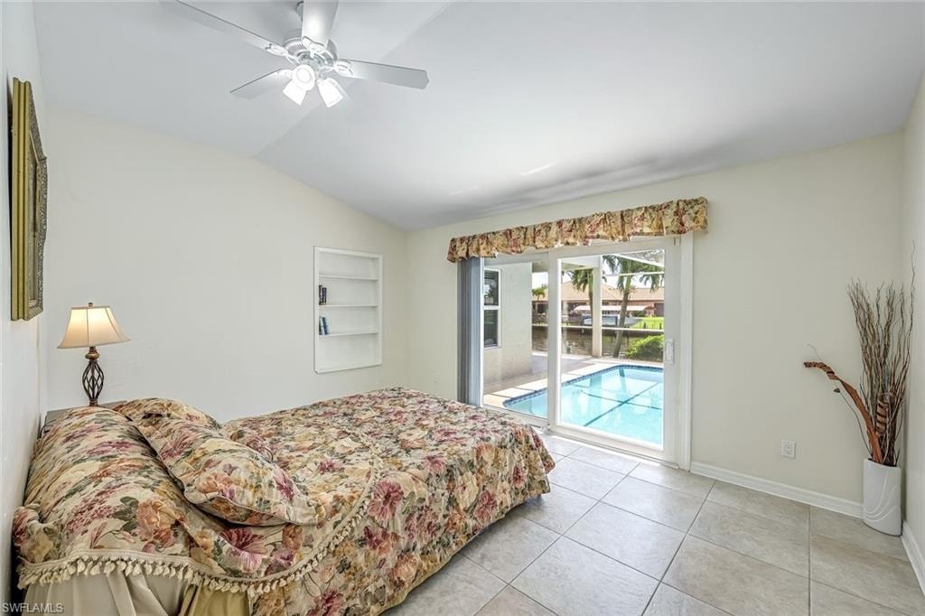 Primary Bedroom with glass slider to Lanai/Pool Area.