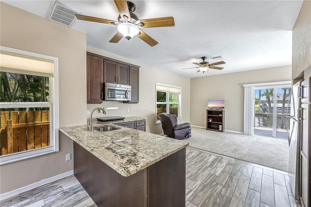 Kitchen and Great Room in Mother-in-Law Suite.  Impact windows with slider to pool area.