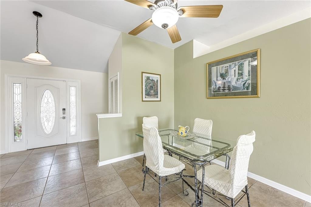 Formal Dining Area looking toward decorative front door with fixed glass panel on each side of door.