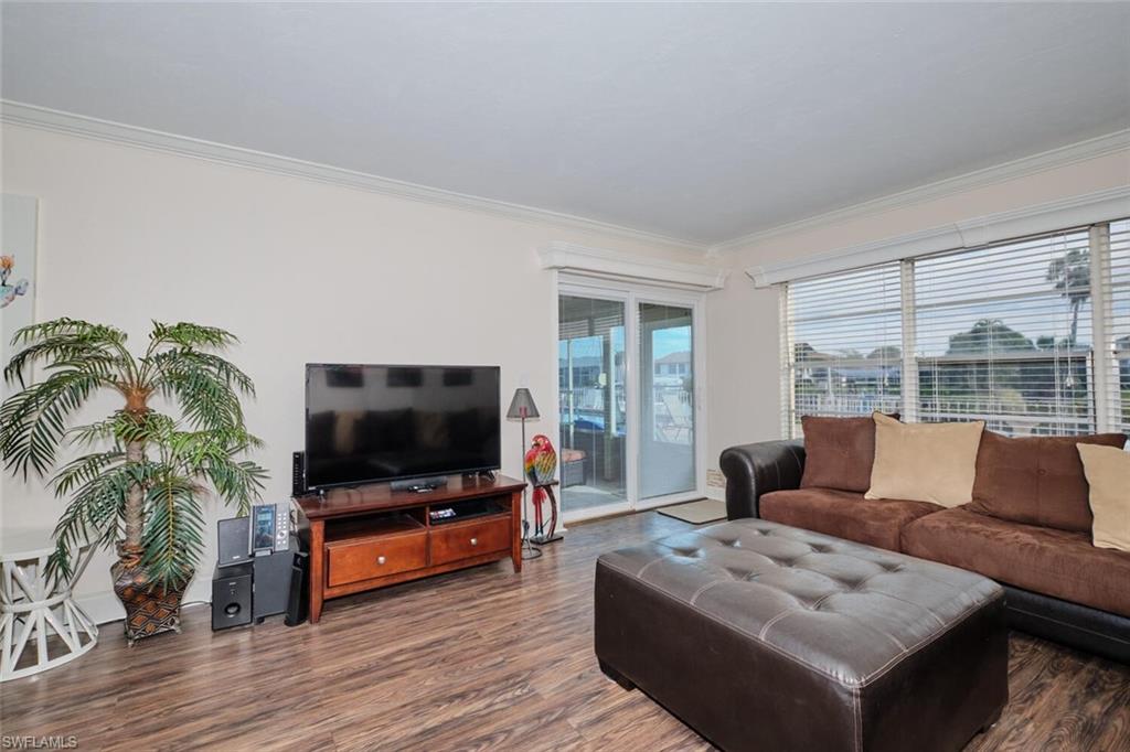 wood-finish flooring, sliding glass doors showing past furniture, unit will have similar type for rental