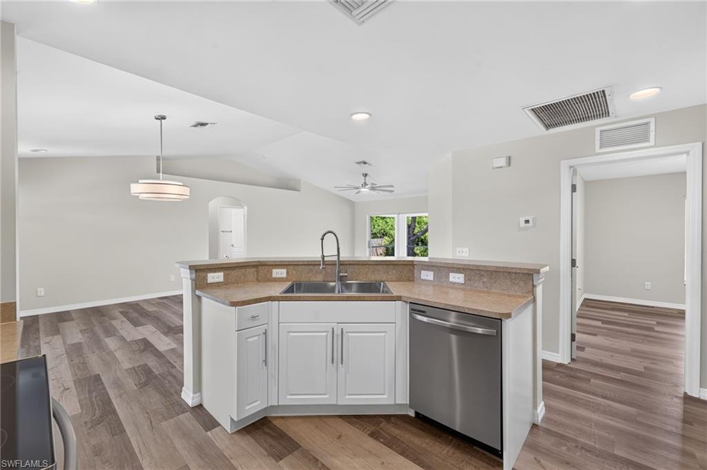 Kitchen island with stainless steel sink, gooseneck faucet, and integrated dishwasher