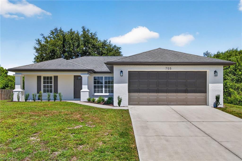 Contemporary exterior with white textured siding, a dark gray shingle roof, and a two-car garage with a paneled door