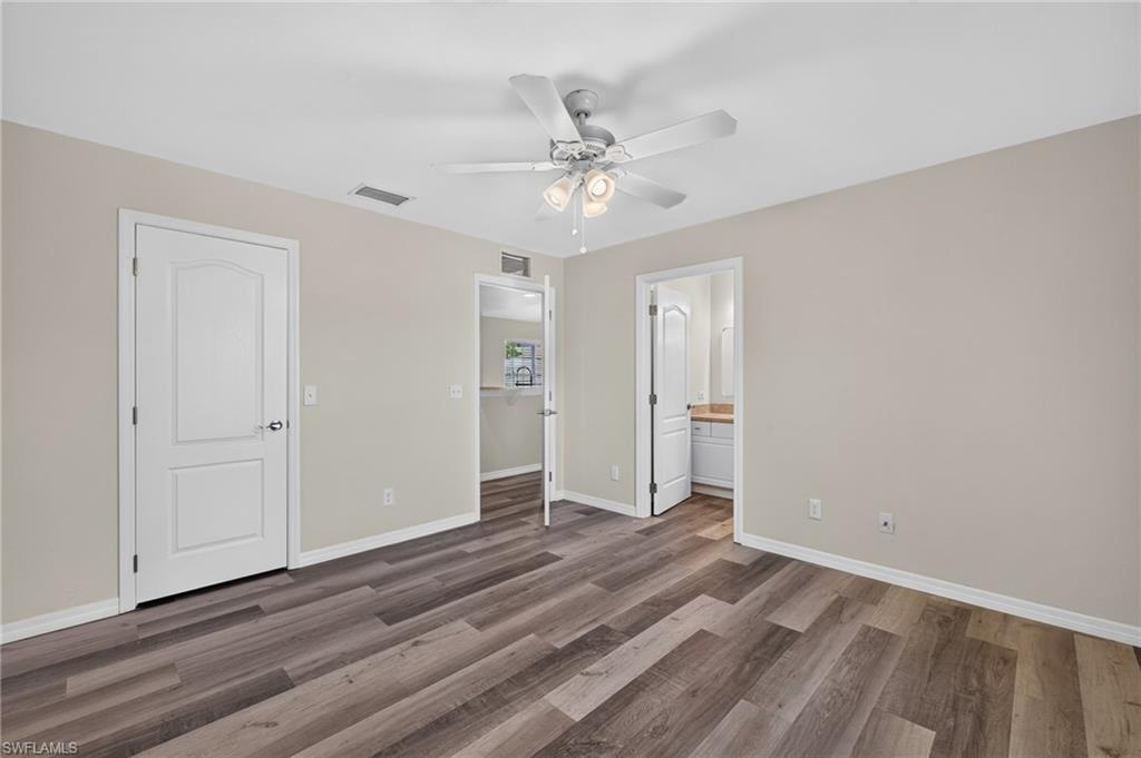 Wood-finish flooring with a ceiling fan light fixture