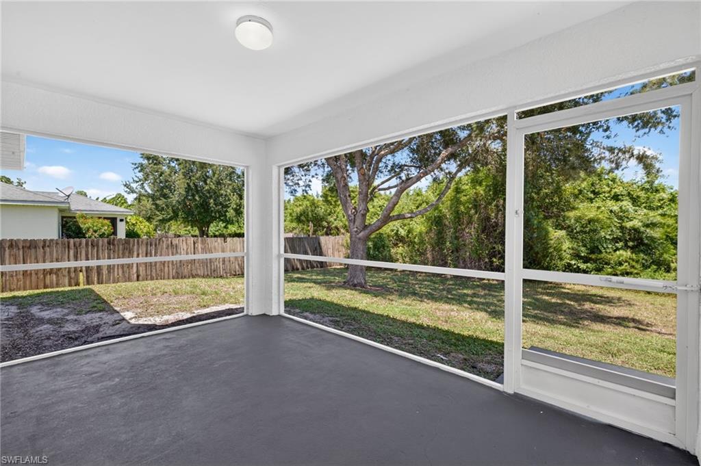 Screened patio with a painted concrete floor and overhead lighting