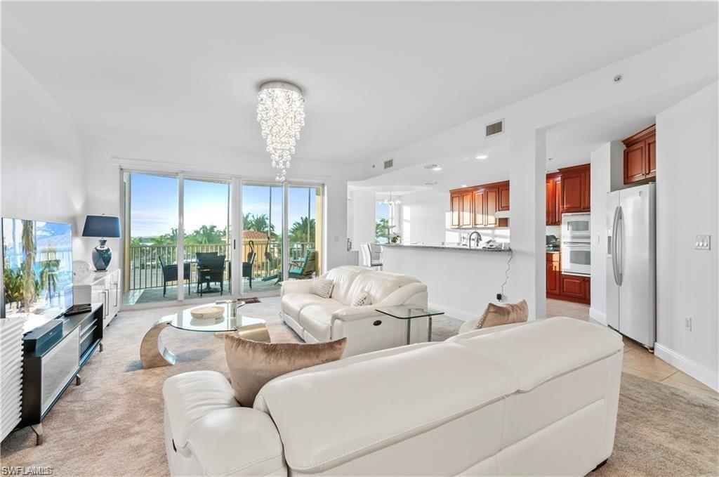 Living room featuring a chandelier, recessed lighting, and light tile patterned floors