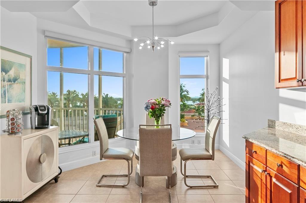 Dining area featuring light tile patterned floors and a chandelier