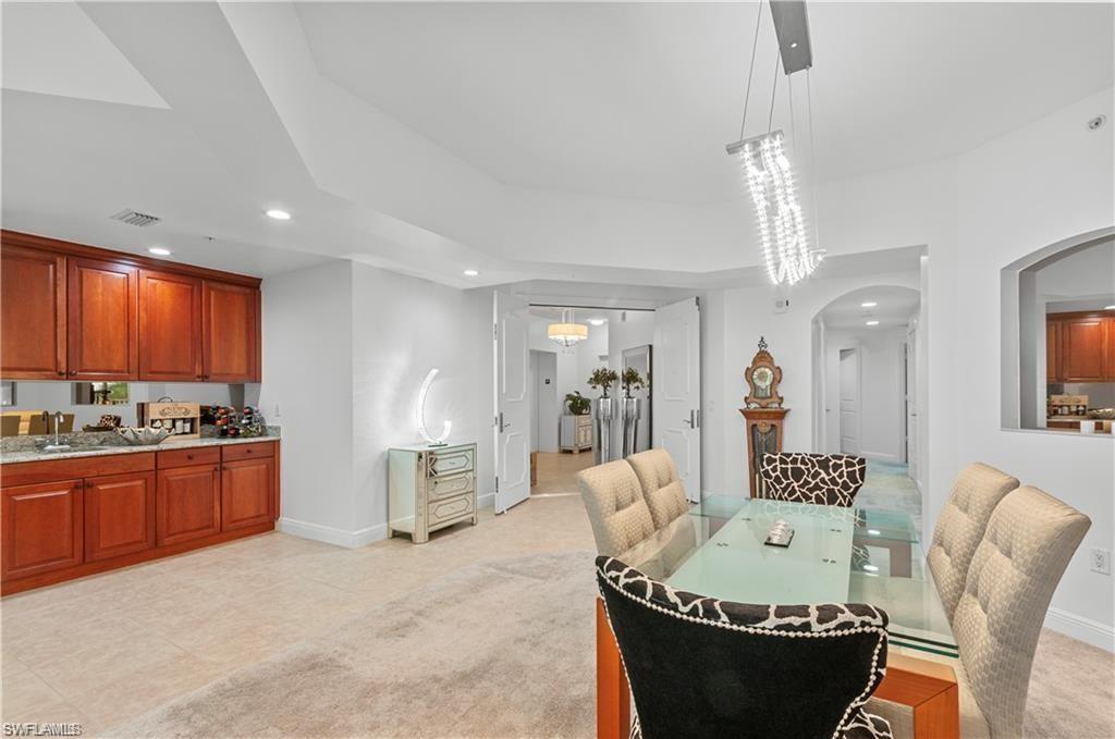 Dining area with recessed lighting, arched walkways, and light tile patterned floors