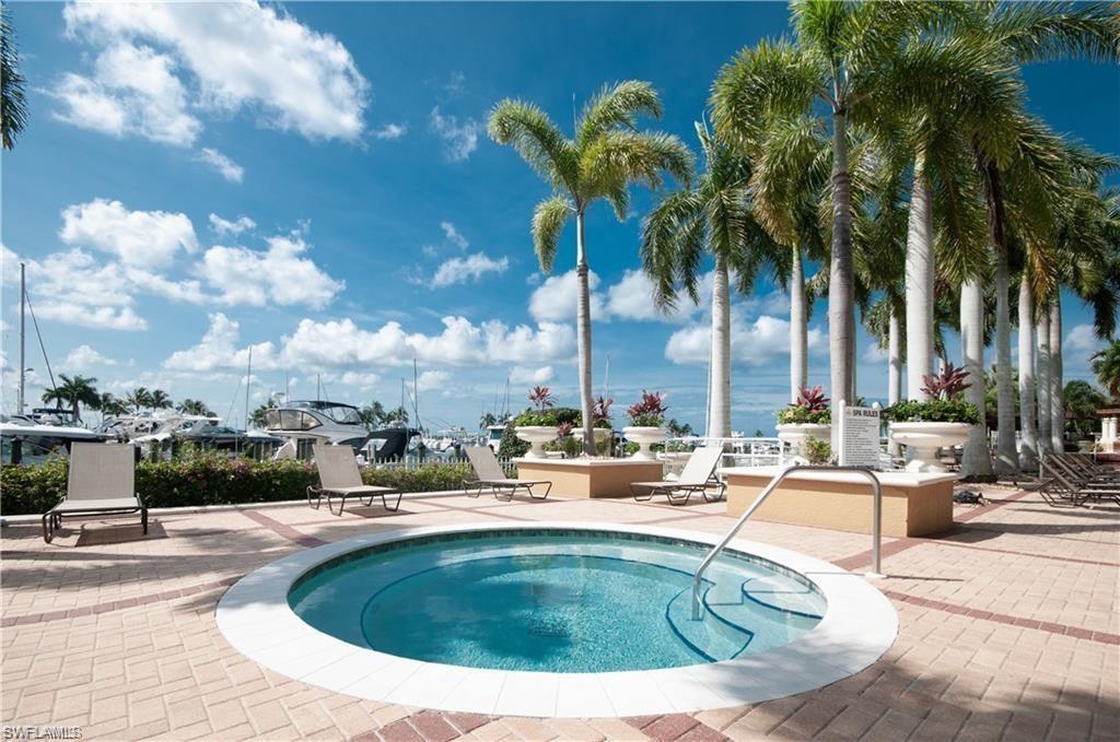 View of pool with a pool, a community hot tub, and a patio area
