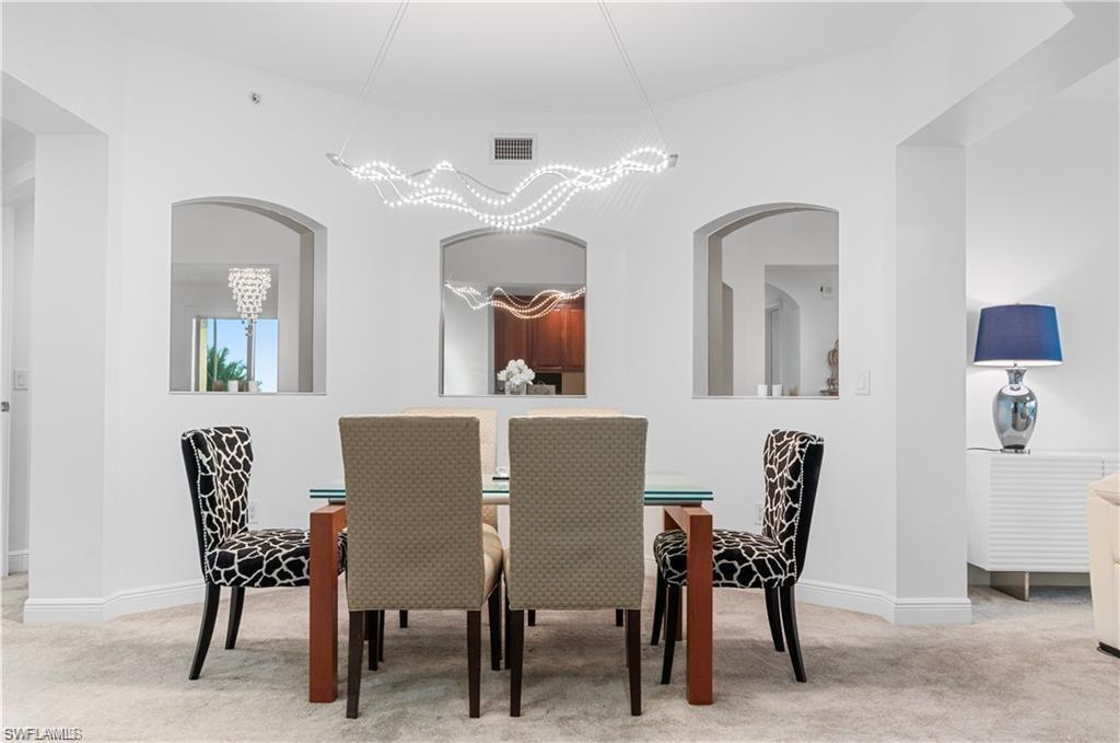 Dining room featuring light carpet and baseboards