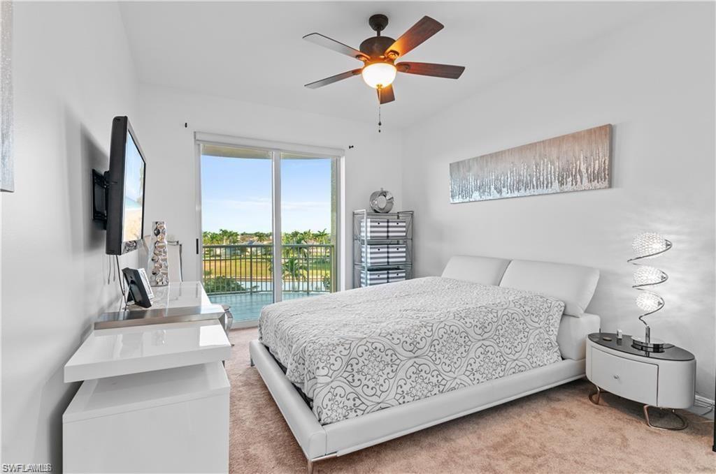 Bedroom featuring access to exterior, ceiling fan, and carpet flooring