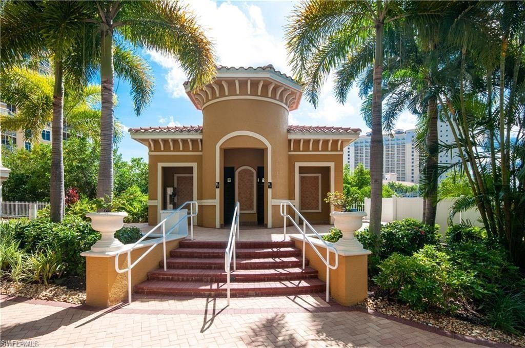 Doorway to property with a porch, a tiled roof, and stucco siding