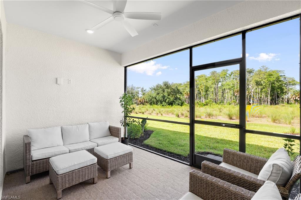 Screened lanai with a ceiling fan, recessed lighting, and textured walls