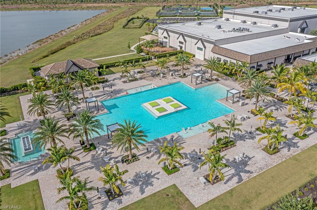 Expansive resort-style pool with integrated sun shelf and a central floating island