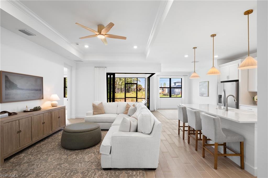 Recessed lighting, tile flooring, and a ceiling fan enhance the living area