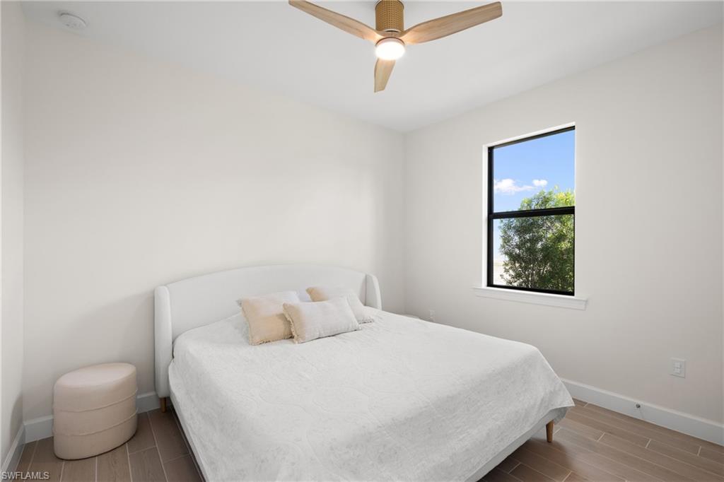 Recessed lighting, wood-finish flooring, and a contemporary ceiling fan