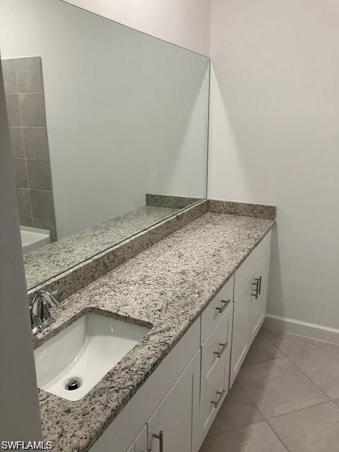 Bathroom with vanity and tile patterned flooring