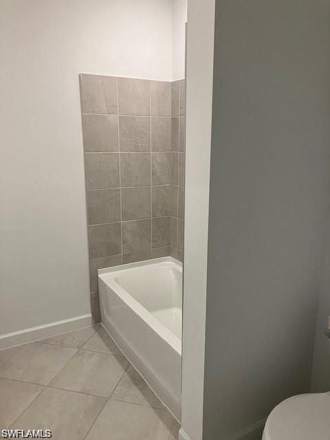 Bathroom with toilet and tile patterned flooring