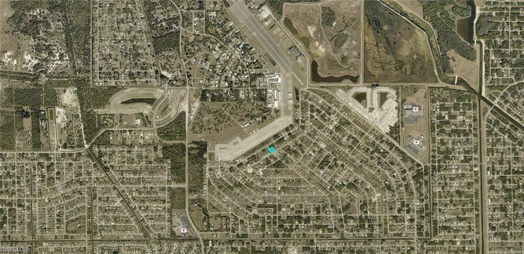 Aerial Map. Displaying the property's location within a residential and commercial area, including an airport and waterways