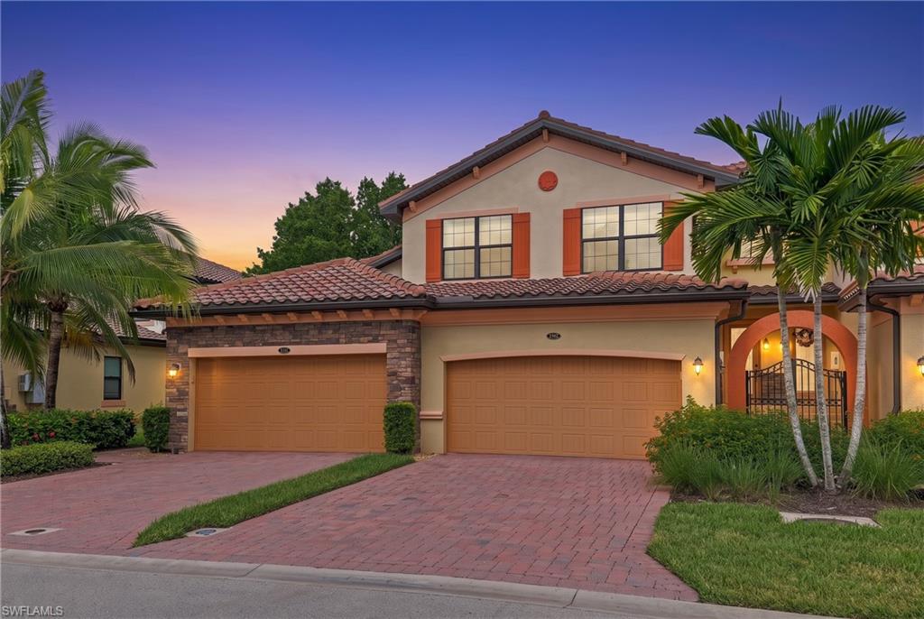 Mediterranean-inspired exterior with a tile roof and decorative stone accents