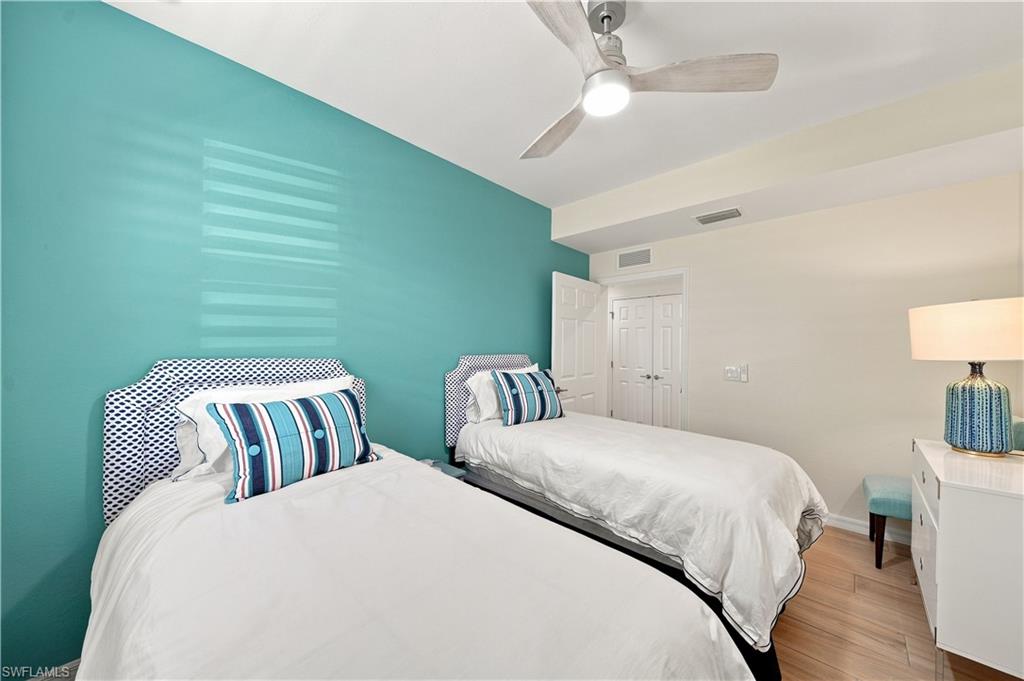 Recessed lighting, wood-finish flooring, ceiling fan, solid core doors, and a window with horizontal blinds