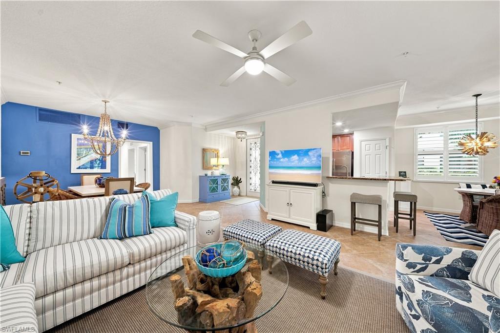 Spacious open-concept living area featuring wood-finish flooring and crown molding