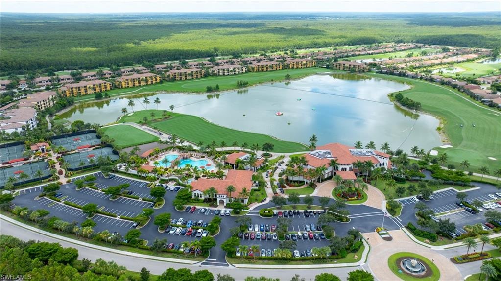 Expansive community with a central lake, golf course, multiple tennis courts, and a large swimming pool