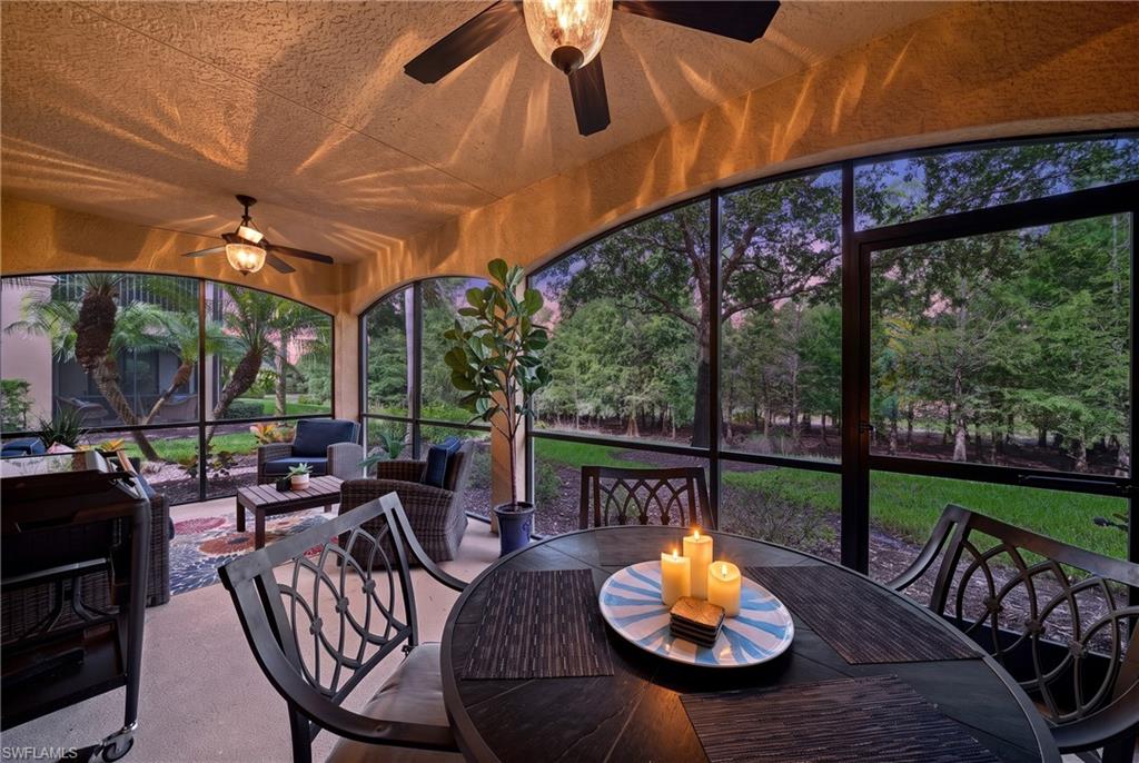 Screened patio with arched openings and ceiling fans