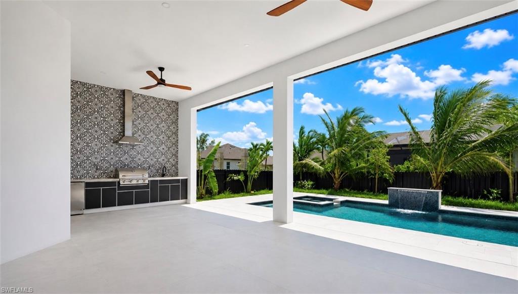 Outdoor kitchen with integrated grill and decorative tile backsplash