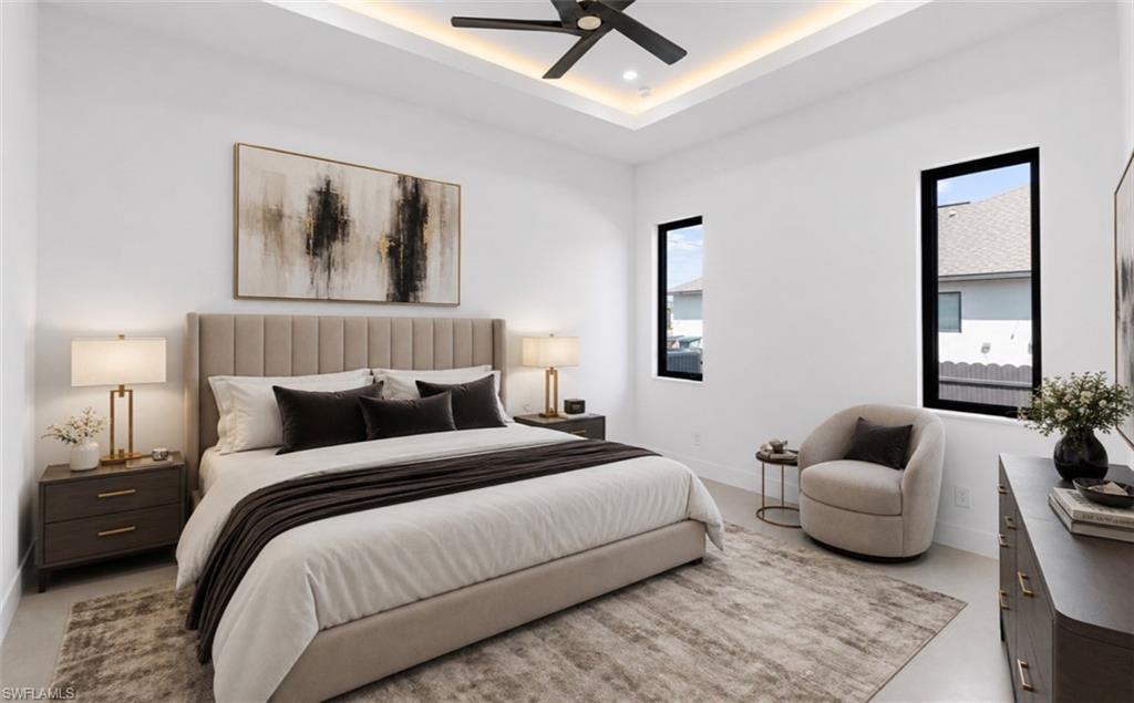 Recessed ceiling with perimeter lighting, ceiling fan, and black-framed windows