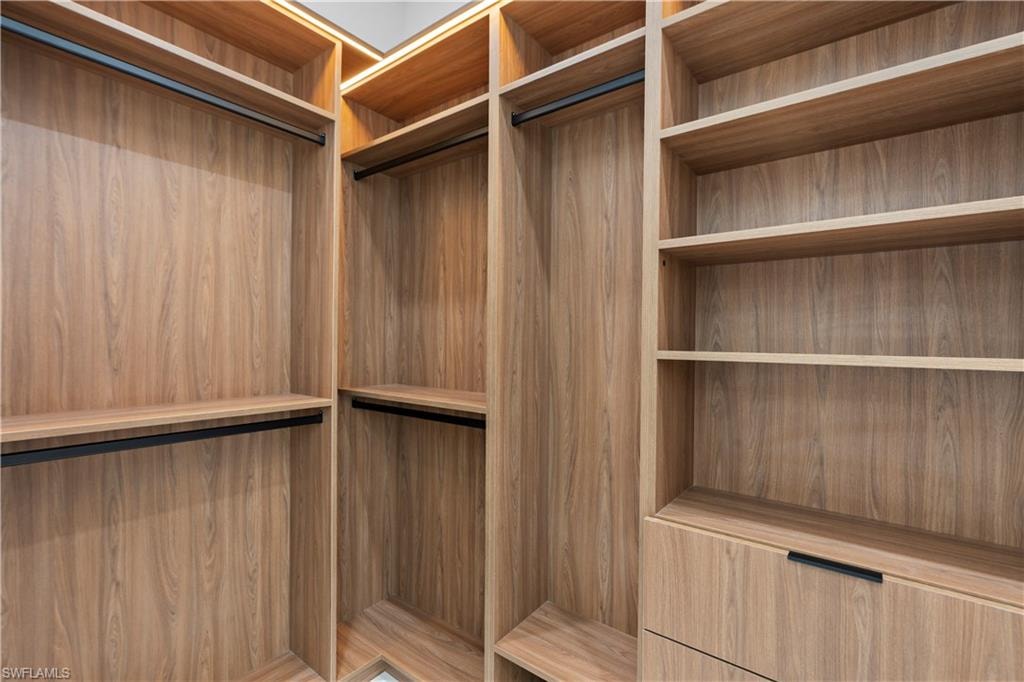 Wood-finish cabinetry featuring integrated lighting