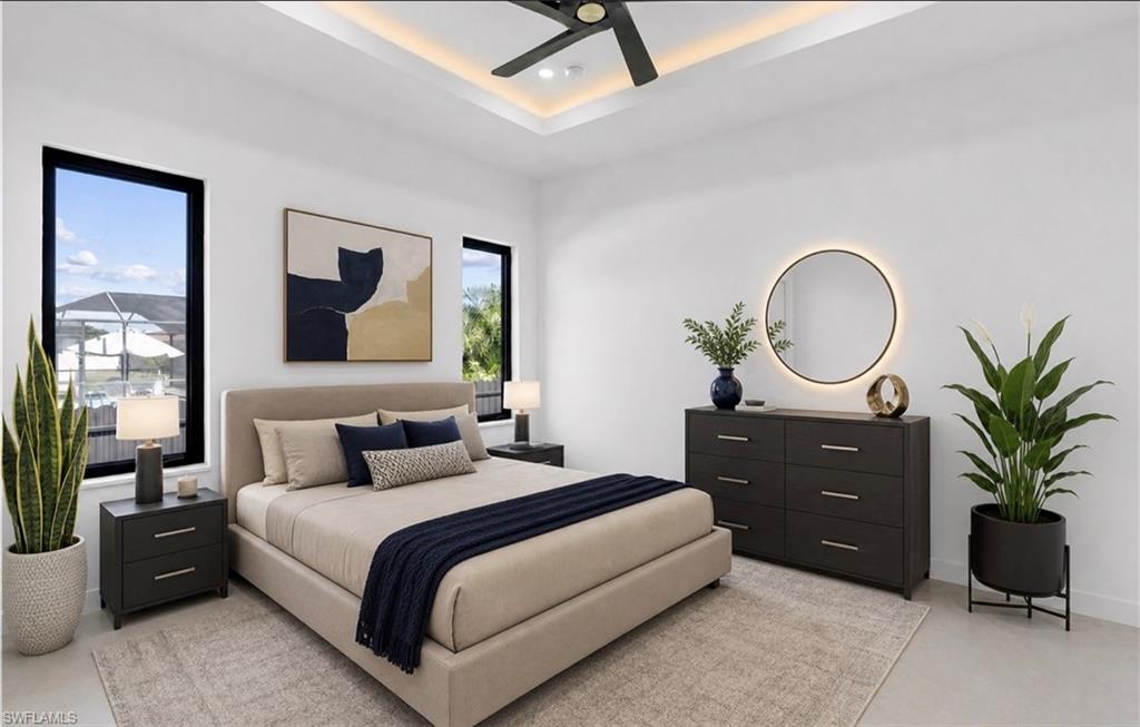 Recessed ceiling with perimeter lighting, ceiling fan, and two large windows