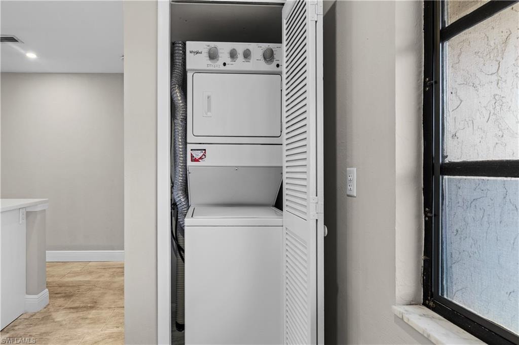 Stackable washer and dryer unit, louvered closet doors, and tile flooring