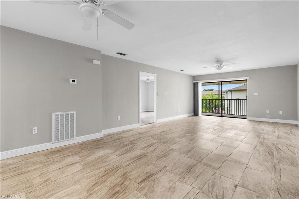 Sliding doors to lanai and primary bedroom entrance off of living room