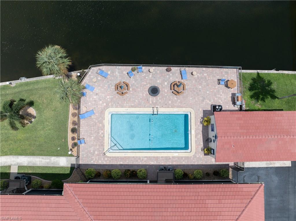Waterfront property with a paver patio and an in-ground swimming pool
