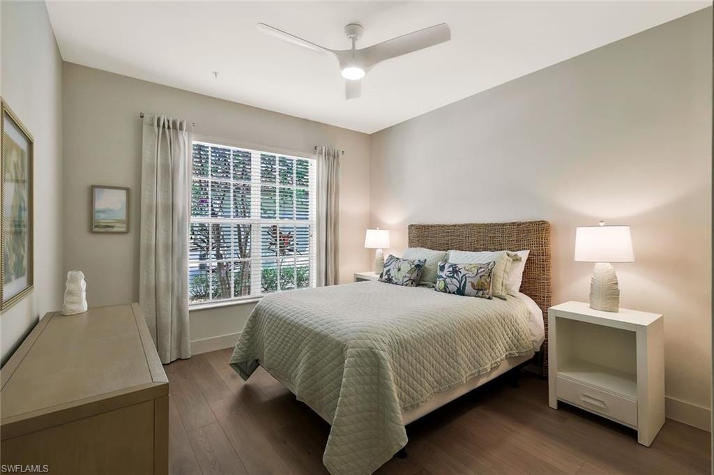 Bedroom featuring wood finished floors, baseboards, and a ceiling fan