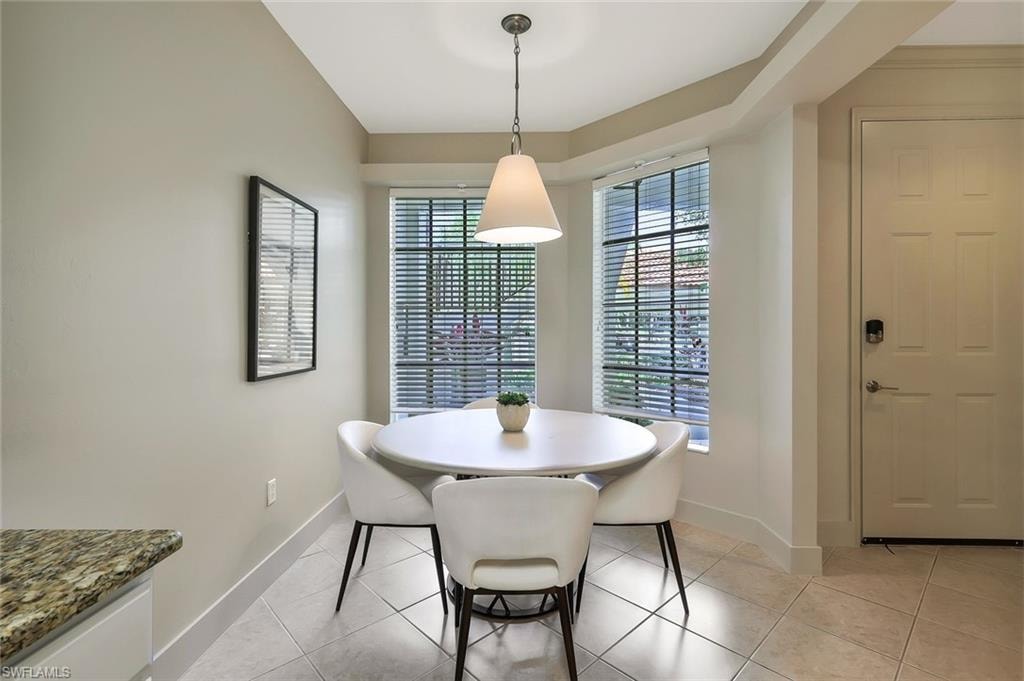 Dining room with baseboards and light tile patterned flooring