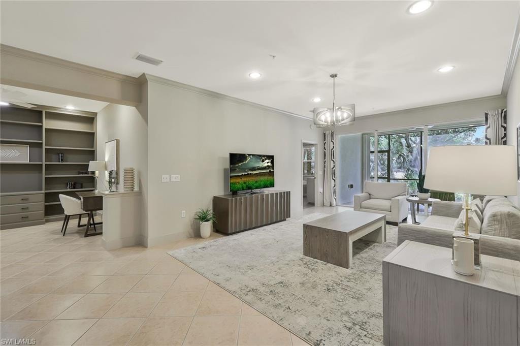 Tiled living room with an inviting chandelier, ornamental molding, visible vents, and recessed lighting