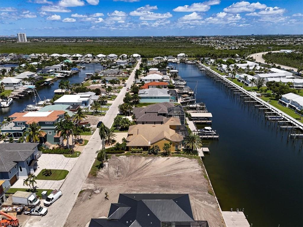 Waterfront property with direct canal access, an existing dock, and a clear, level lot ready for development