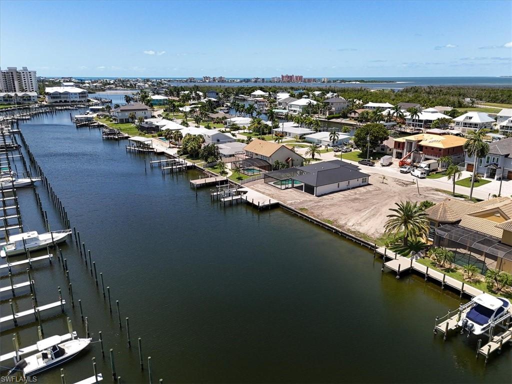 Waterfront property featuring a canal, private boat docks, and direct water access