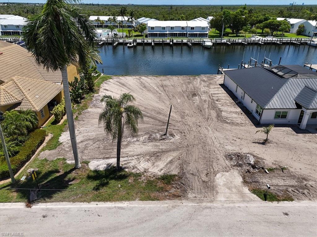 Cleared parcel with waterfront access, featuring a seawall and direct water frontage