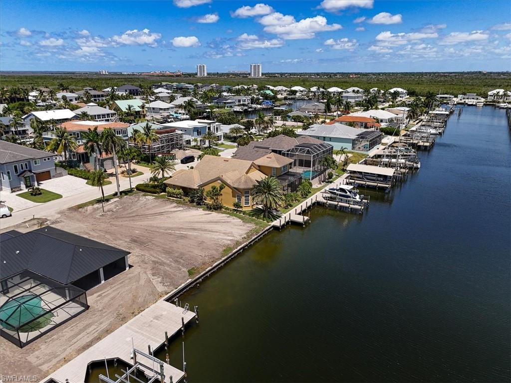 Vacant lot with waterfront access, featuring a private boat dock and a boat lift