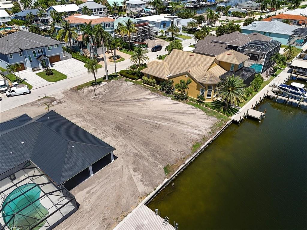Waterfront lot featuring direct canal access, an existing seawall, and a clear, level building site