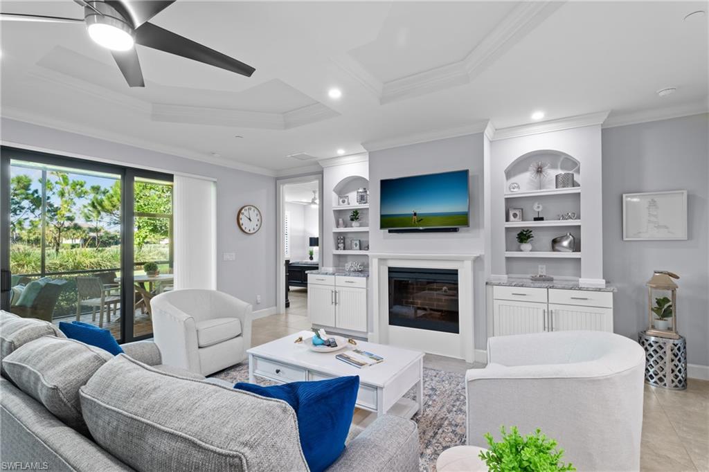 Recessed lighting illuminates the coffered ceiling with a modern ceiling fan