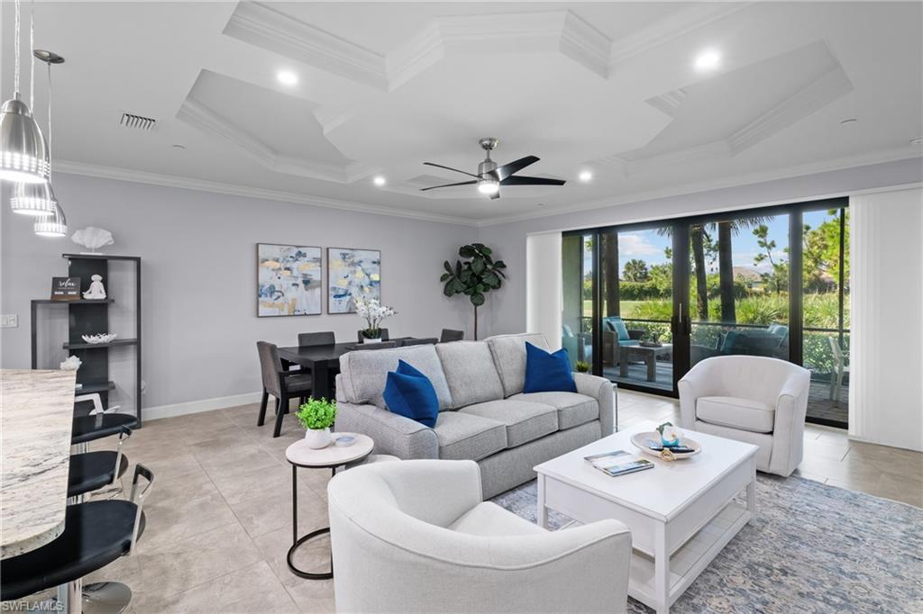 Tray ceiling details, recessed lighting, ceiling fan, tile flooring, and sliding glass doors to exterior