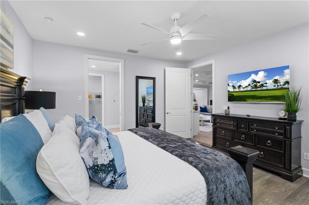 Recessed lighting, ceiling fan, wood-finish flooring, and white trim throughout